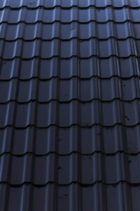 a close up of a metal roof with a sky background